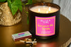 Burning 3 Wick Jamaican Me Crazy candle with a box of matches on gold table from illuminate B. Candles